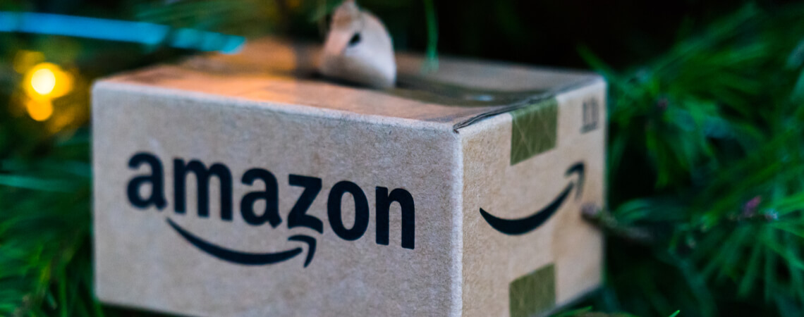 Rückgabefristen 2021: Kleines Amazon-Paket an einem Weihnachtsbaum