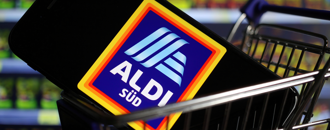 Aldi Süd-Logo auf Smartphone in Einkaufswagen